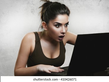 Shocked Woman Reading News On Laptop