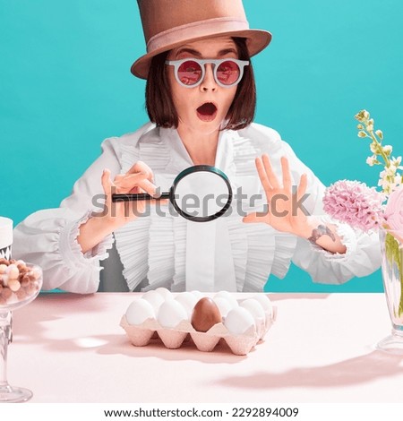 Shocked woman in sunglasses and cylinder hat emotionally looking in magnifying glass at chocolate eggs among ordinary. Concept of pop art, creativity, food, inspiration, holidays, emotions