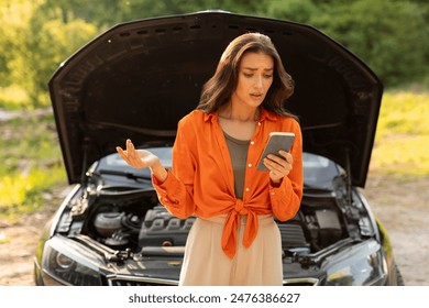 Shocked woman using cellphone while standing by broken down car on roadside, reading message or searching for assistance - Powered by Shutterstock