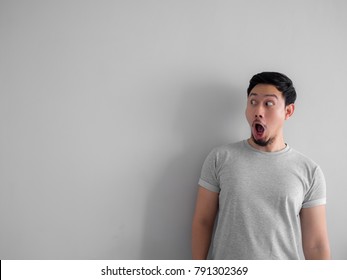 Shocked And Wow Face Of Asian Man With Beard In Grey T-shirt.