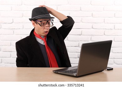 Shocked Young Business Man Using Laptop Looking At Computer Screen Blown Away In Stupor Sitting Outside Corporate Office. Human Face Expression, Emotion, Feeling, Perception, Body Language, Reaction