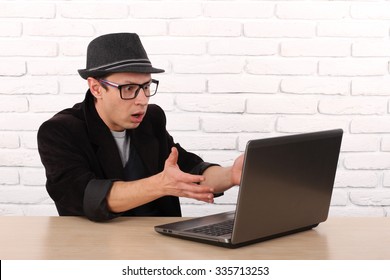 Shocked Young Business Man Using Laptop Looking At Computer Screen Blown Away In Stupor Sitting Outside Corporate Office. Human Face Expression, Emotion, Feeling, Perception, Body Language, Reaction