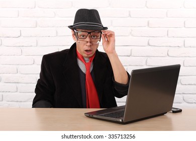 Shocked Young Business Man Using Laptop Looking At Computer Screen Blown Away In Stupor Sitting Outside Corporate Office. Human Face Expression, Emotion, Feeling, Perception, Body Language, Reaction