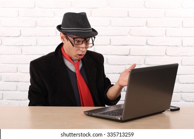 Shocked Young Business Man Using Laptop Looking At Computer Screen Blown Away In Stupor Sitting. Human Face Expression, Emotion, Feeling, Perception, Body Language, Reaction