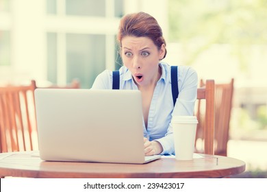 Shocked Young Business Woman Using Laptop Looking At Computer Screen Blown Away In Stupor Sitting Outside Corporate Office. Human Face Expression, Emotion, Feeling, Perception, Body Language, Reaction