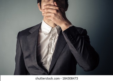 Shocked Young Businessman Covering Is Mouth