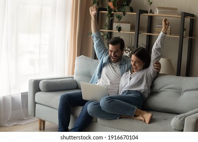 Shocked young family couple cuddle on sofa raise hands scream wow read email with great news on laptop screen. Lucky husband wife celebrate winning lottery getting great offer proposal for purchase - Powered by Shutterstock