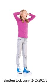 Shocked Young Girl Young Holding Head And Looking Up. Full Length Studio Shot Isolated On White.