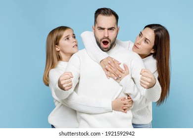 Shocked Young Parents Mom Dad With Child Kid Daughter Teen Girl In Basic White Sweaters Hold Hands Like Driving Car Hugging Like Safety Belt Isolated On Blue Background. Family Day Parenthood Concept