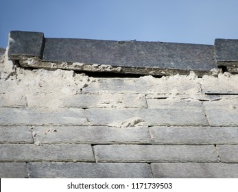 Shoddy Roofing Work By Cowboy Builder. Results Of Rogue Worker Posing As Skilled Tradesman. Badly Pointed Ridge Tiles On Slate Roof, Mortar Running Down Tiles. Close Up Detail.