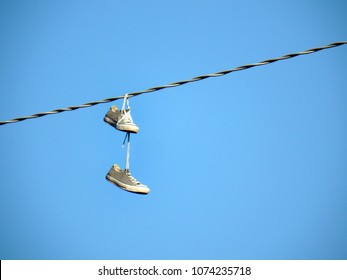 Shoe Dangling Or Shoe Flinging, Is The Practice Of Throwing Shoes Whose Shoelaces Have Been Tied Together So That They Hang From Overhead Wires Such As Power Lines Or Telephone Cables.