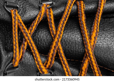 Shoe lacing close up. Shoelaces crossing. Orange Shoelaces.