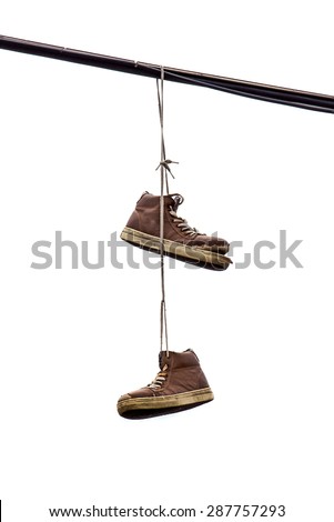 Shoe Tossing, Old Sneakers Hanging on Power line Wire, Isolated on White Background