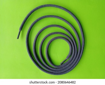 shoelace knot on green background