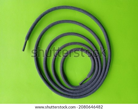 shoelace knot on green background