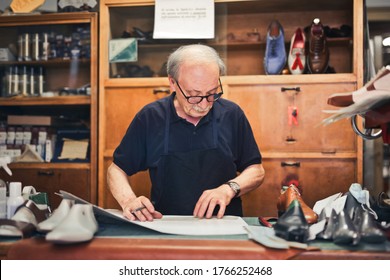 shoemaker craftsman in his workshop - Powered by Shutterstock