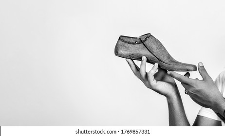 Shoemaker holding wooden footwear. Copy space. Man hands holding last shoe. New idea for start up. Modelling shoes business. - Powered by Shutterstock