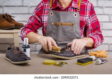 Shoemaker, Man Shining Shoes With A Brush. Footwear Repair.