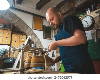 Shoemaker working with lasts repairing shoes. Trades, business.  - Powered by Shutterstock