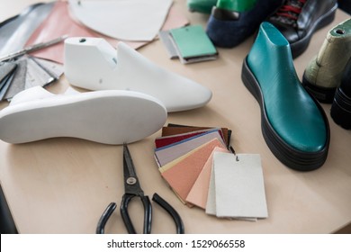 Shoemaker workplace with tools, shoes, leather and last. - Powered by Shutterstock