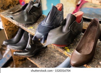 Shoes being manufactured (in process) in a shoes factory / workshop. They are on shelves. Sneakers, boots, heels. Taken in Restrepo, Bogota, Colombia. - Powered by Shutterstock