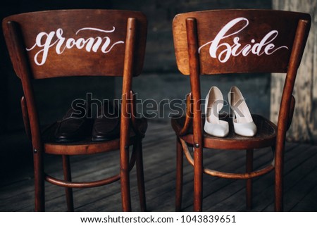 shoes the bride and groom are standing on wooden signed chairs the bride and groom on a wooden background