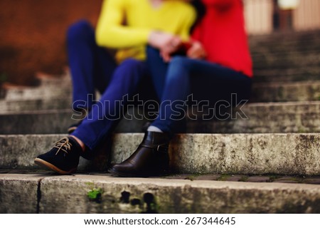 shoes of couple sitting on stairs in Rome