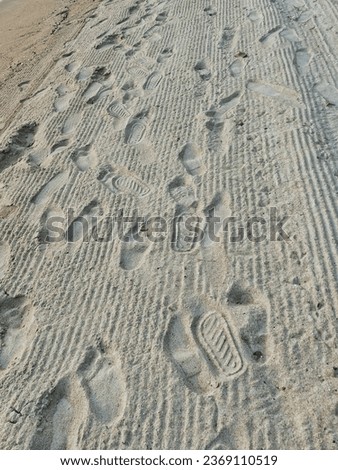 Shoes footstep in print trace on the sandy beach