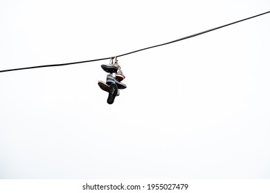 Shoes Hang On Laces On A Wire Overhead