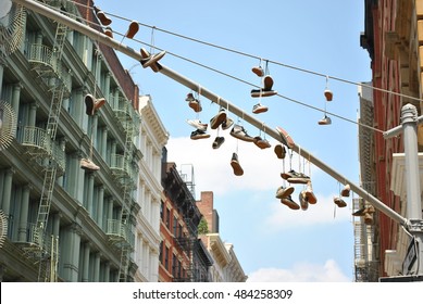 Shoes Hanging From An Electric Pole In SoHo, NY.