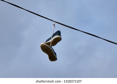 Shoes Hanging On A Cable