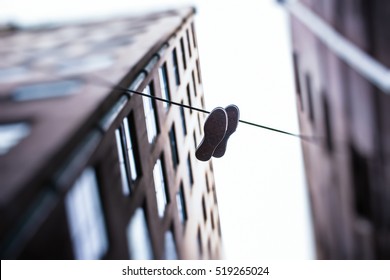 Shoes hanging from wires - Shutterstock ID 519265024
