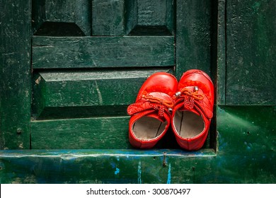 Shoes Left At A Green Door