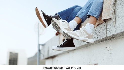 Shoes, legs and couple on rooftop in the city sitting together, have fun and bonding. Fashion sneakers, style and friends kick feet on building edge, enjoy weekend, freedom and holiday in urban town - Powered by Shutterstock