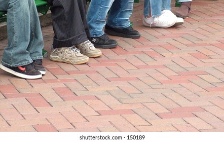 Shoes Lined Up On Brick Walkway