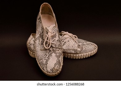 Shoes Made Of Snake Skin On A Dark Background.