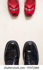 Shoes Of A Man And A Woman Standing Opposite On The Floor