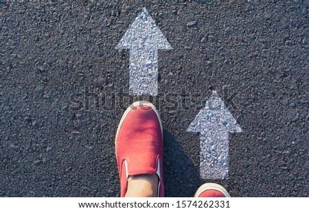 Shoes standing at the crossroad and get to decision which way to go. Ways to choose concept.