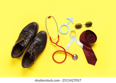 Shoes, stethoscope, tie, male sign and light blue ribbon on yellow background. Prostate cancer awareness - Powered by Shutterstock