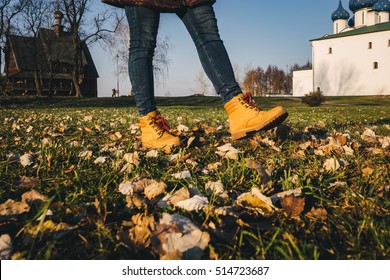 Shoes with yellow fallen leaves in autumn