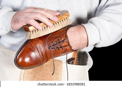 A Shoeshine Man Polishing A Leather Dress Shoe