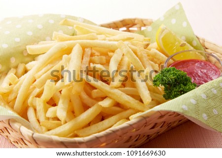 Shoestring style french fries with ketchup in basket