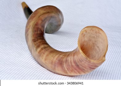 Shofar (horn) From The Horn Of A Greater Kudu On Rosh Hashanah And Yom Kippur High Holidays. Isolated On White Background. Traditional Jewish Holiday Symbol. No People. Copy Space