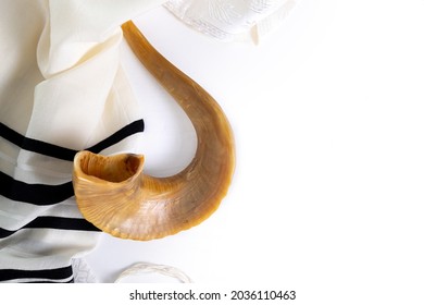Shofar (horn) and tallit on a white background. Traditional symbol of the Jewish holiday. Top view