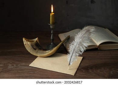 Shofar (horn), Torah book, burning candle, sheet of paper and feather pen. Jewish holiday of Yom Kippur