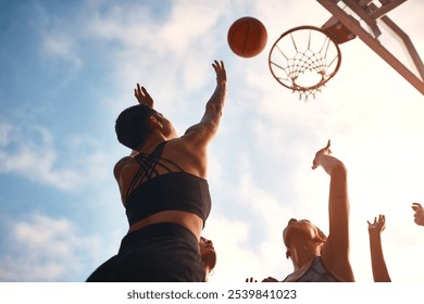 Shoot, basketball and women with ball, sport and practice for game, outdoor and training for match and fitness. Air, friends and low angle for competition or bonding together for teamwork and campus - Powered by Shutterstock