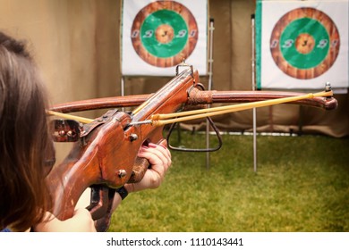 Shooter in the dash prepares for a shot and aims a crossbow at the target. Toned