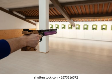 Shooter With Professional Air Gun, During Training At The Firing Range. Electronic Target System.
