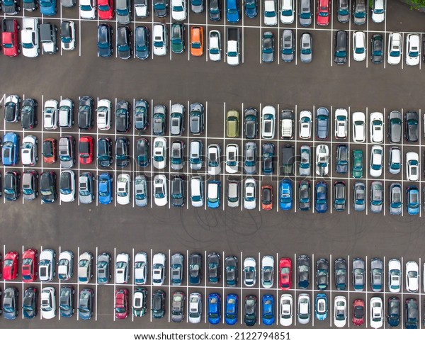Shooting from a drone.\
Asphalted area, car parking. Lots of cars parked in a row.\
Planning, map, urban infrastructure, environmental protection.\
There are no people in the\
photo.
