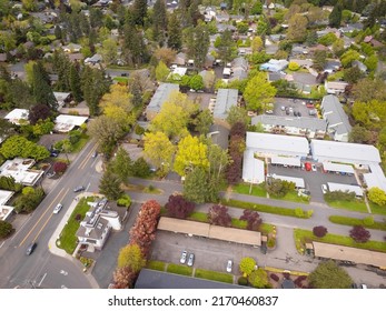 Shooting from a drone. Town, suburb. Lots of greenery, paved roads. Roofs of small one-story houses. Map, topography, planning, design, design, travel, tourism.